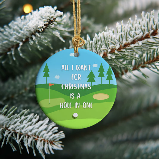 Golf Christmas ornament has the words All I Want for Christmas is a Hole in One with the golf course in the background.